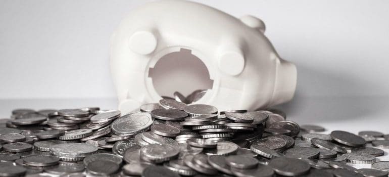 Coins spilling out of a piggy bank.