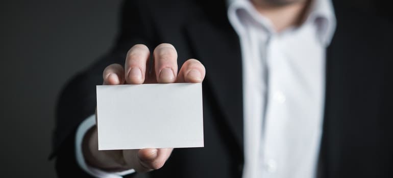 a businessman holding a card 