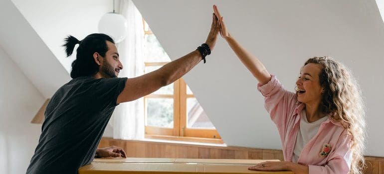 two people high fiving