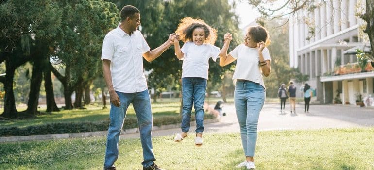 a man woman and a child in a park