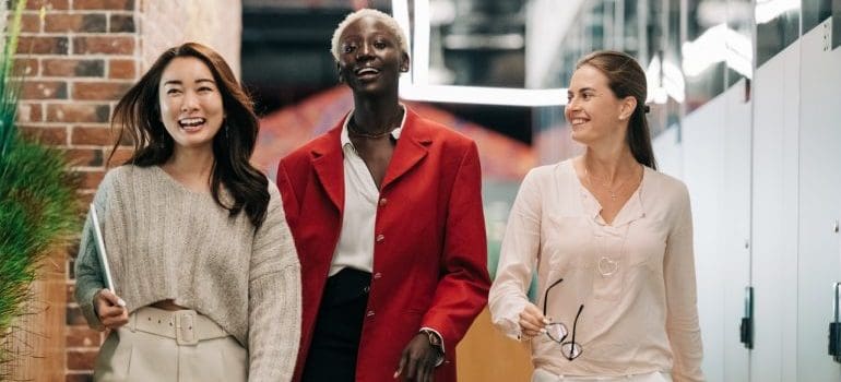 A group of diverse colleagues walking and smiling.