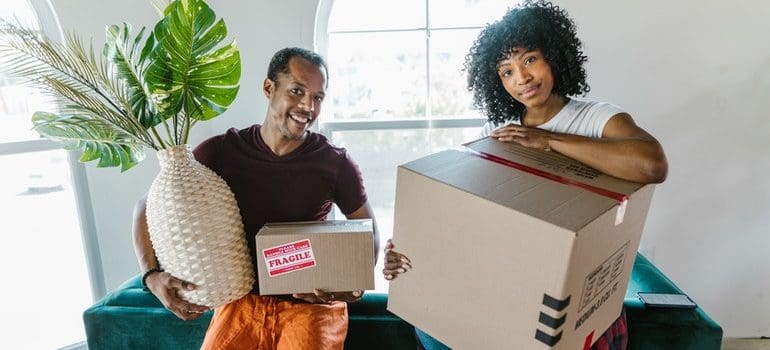 a man and a woman holding boxes