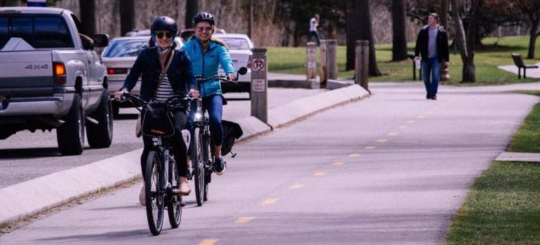 Two womn riding bikes.