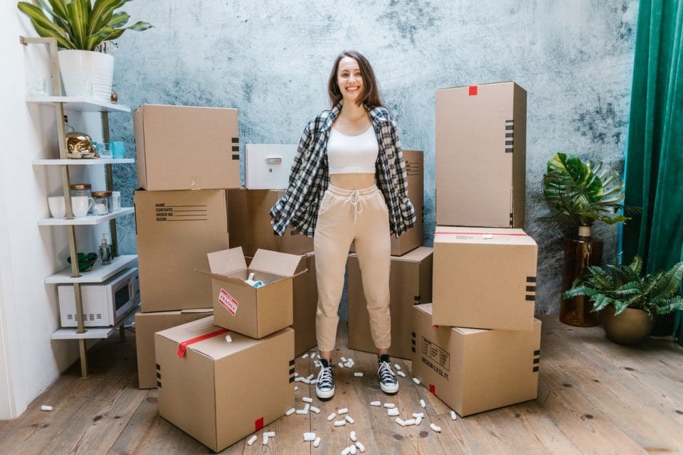 A girl standing between boxes