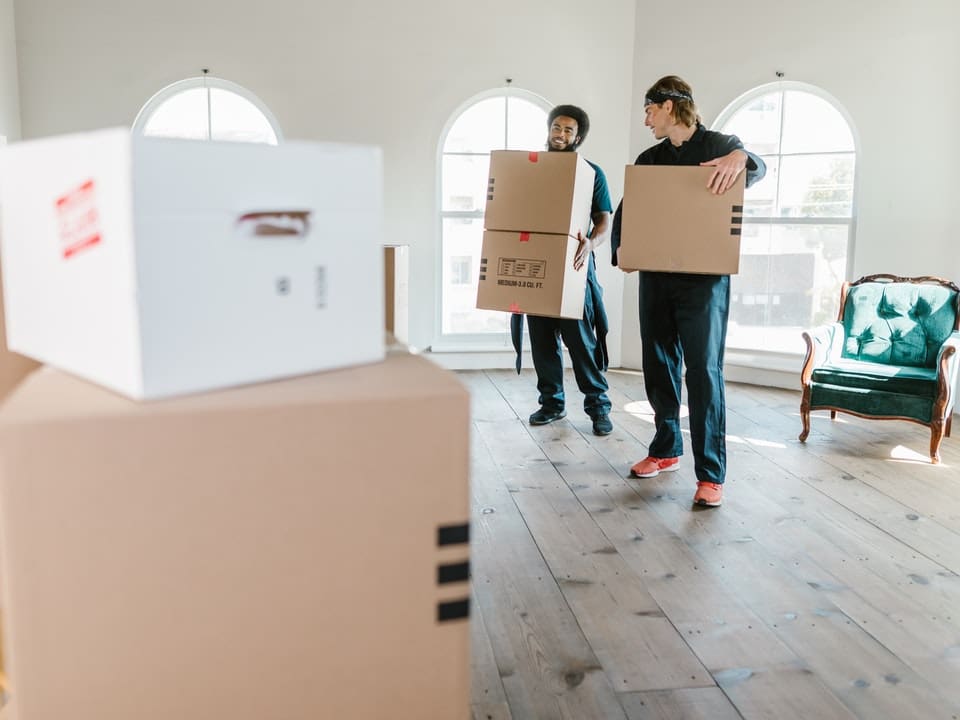 Two movers holding boxes