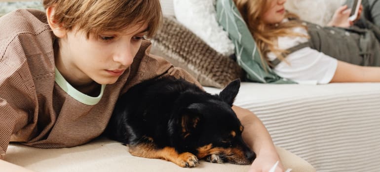 a guy reading with his dog