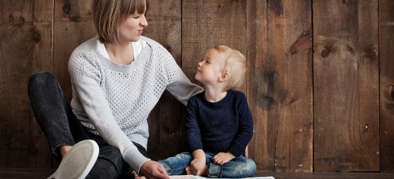 mother smiling with a kid after moving to best parts of NYC for single parents