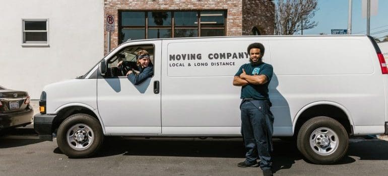 Professional movers beside the van