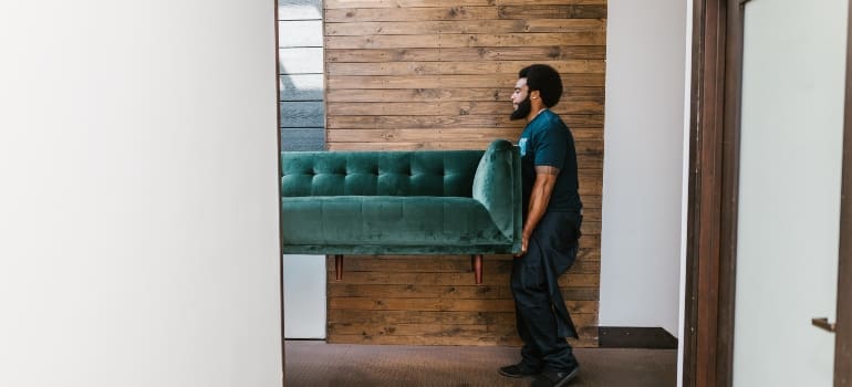 guy carrying sofa