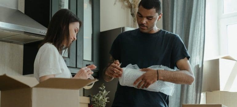 man and woman packing for the move