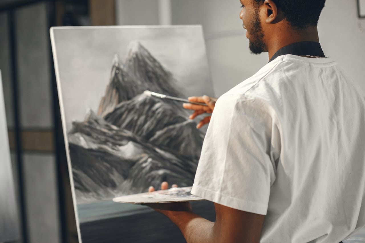 man painting on the canvas