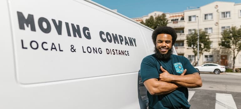 A man in front of the van can tell you where to find reliable movers for your Astoria relocation