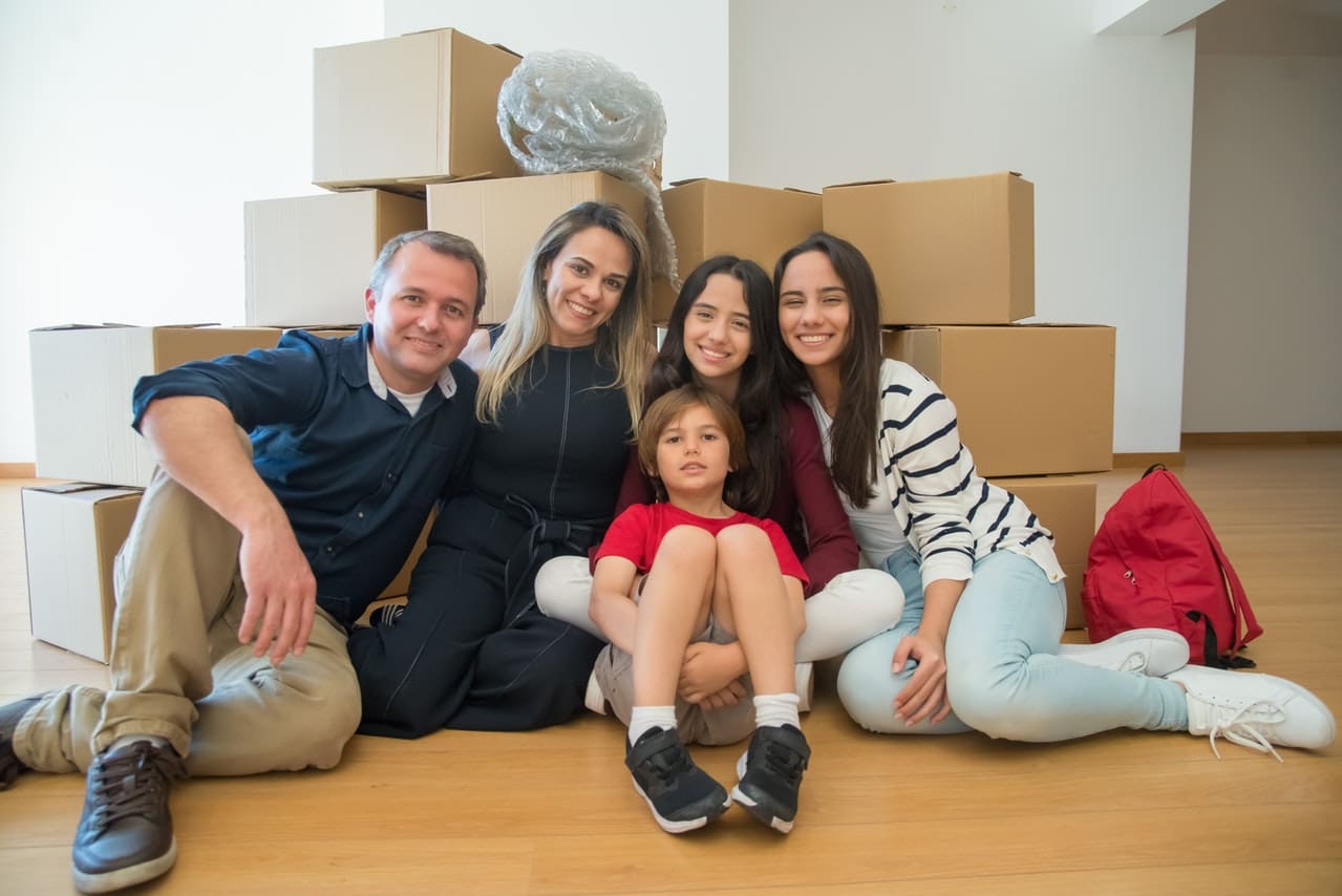 A family in front of moving boxes