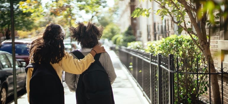 Two girls with school bags