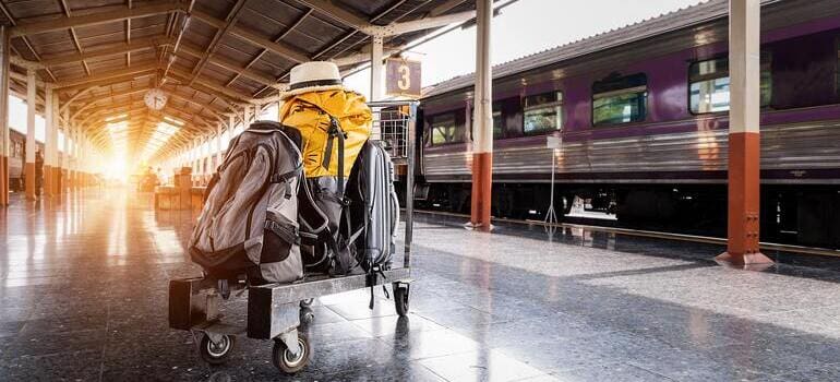 dolly with suitcases at the train station