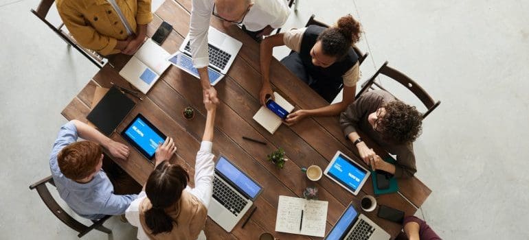 A group of people working together on laptops.