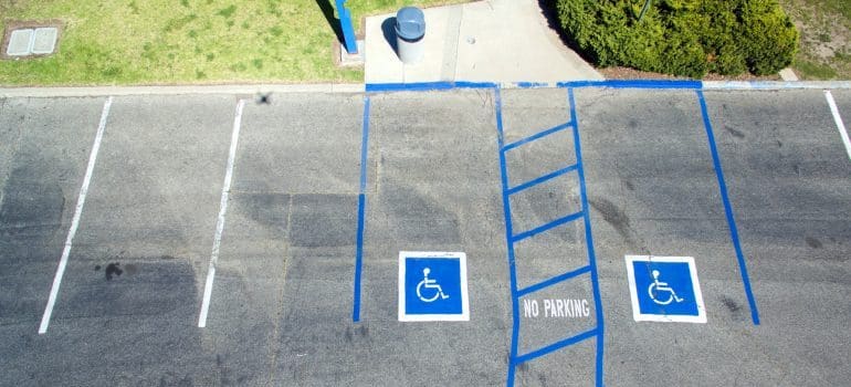 A parking lot with designated areas for disabled people.