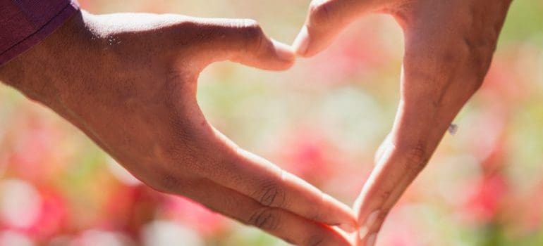 A couple making a heart with their hands