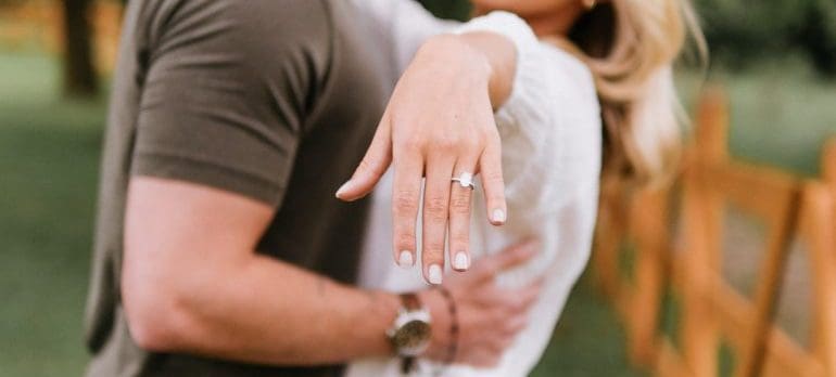 A woman showing her engagement ring