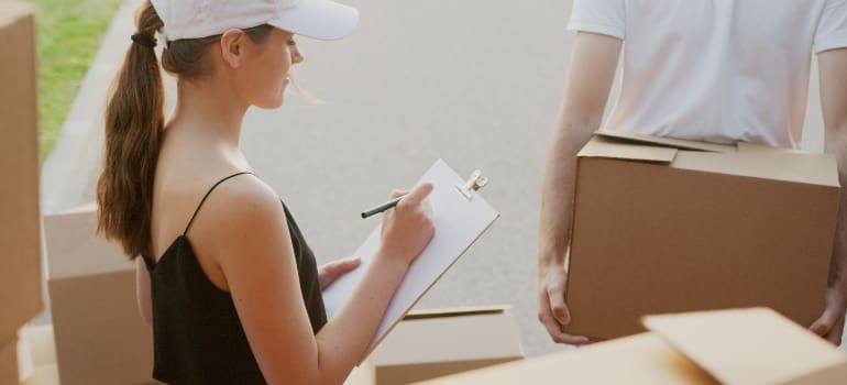 Woman writing down the Benefits of Professional Packing Services