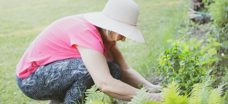 a woman with a hat gardening