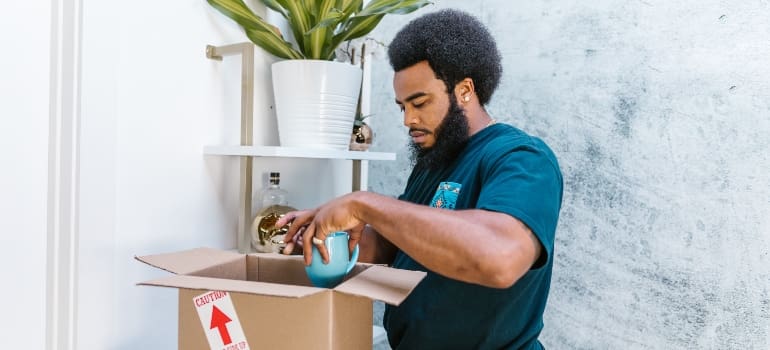 A man packing a mug