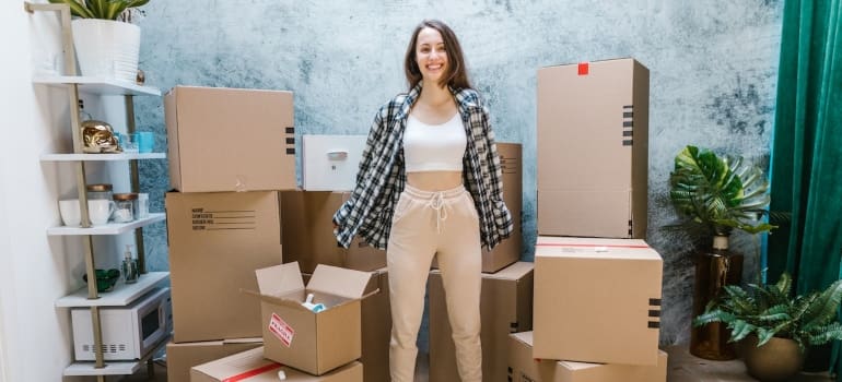 a girl standing between boxes