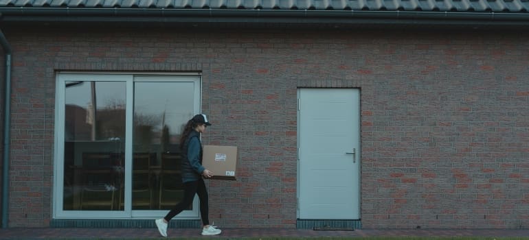 A woman carrying a box