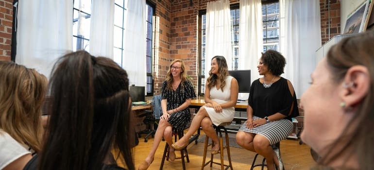 three women at the community meeting