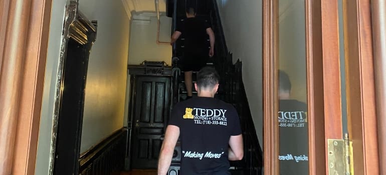two movers entering a house
