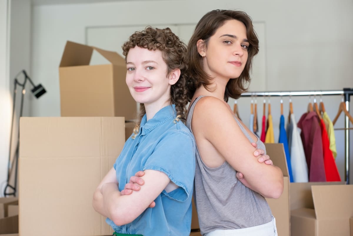 two girls smiling and preparing for the move