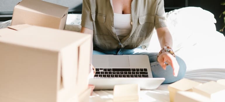 A woman looking up what to do with empty boxes on her laptop