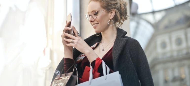 Woman looking up New York neighborhood acronyms on her phone