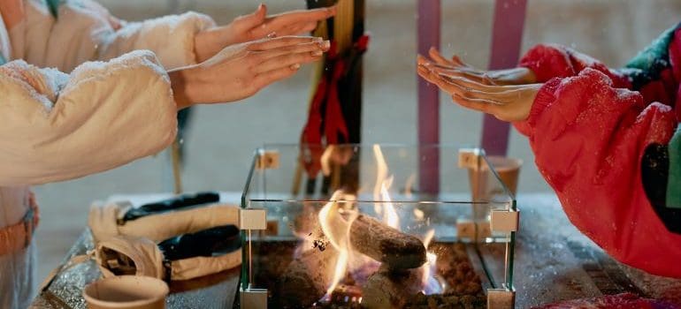 two women warming up their hands